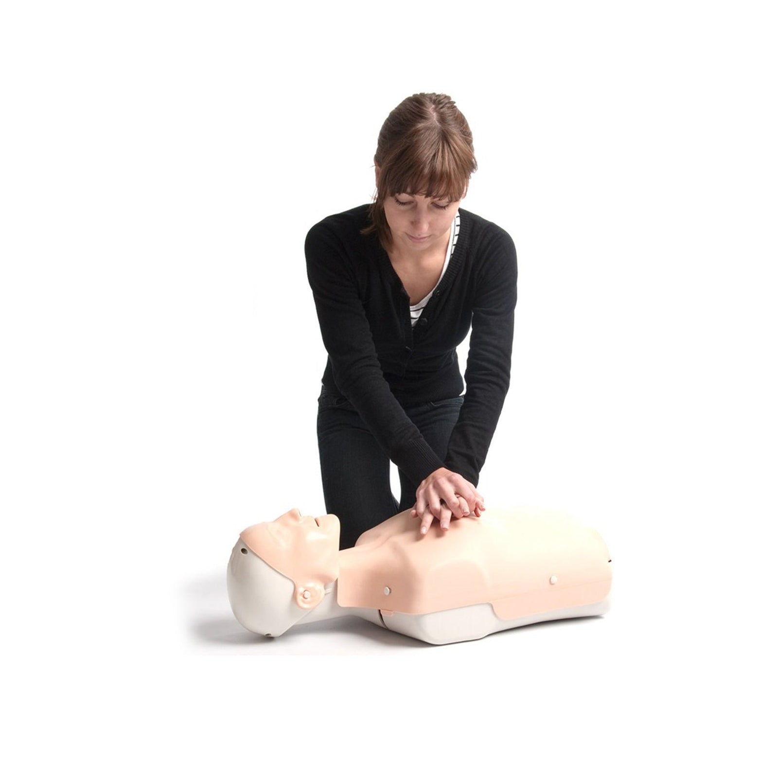 A woman performs CPR chest compressions on a training manikin against a white background.