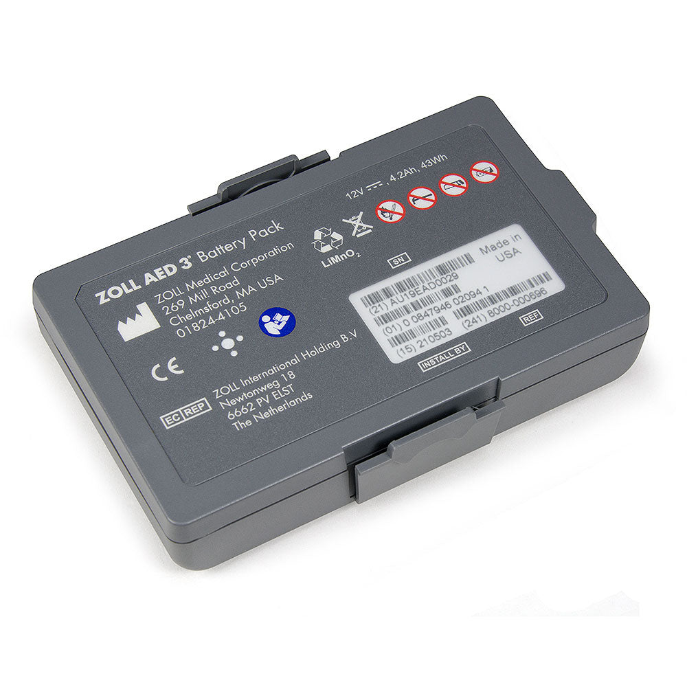 The ZOLL AED 3 Battery Pack from ZOLL is a rectangular, gray battery with a labeled front surface displaying manufacturer information, usage symbols, and a barcode. This Lithium Manganese Dioxide battery provides a 12V, 2.8 Ah power source for the defibrillator accessory.