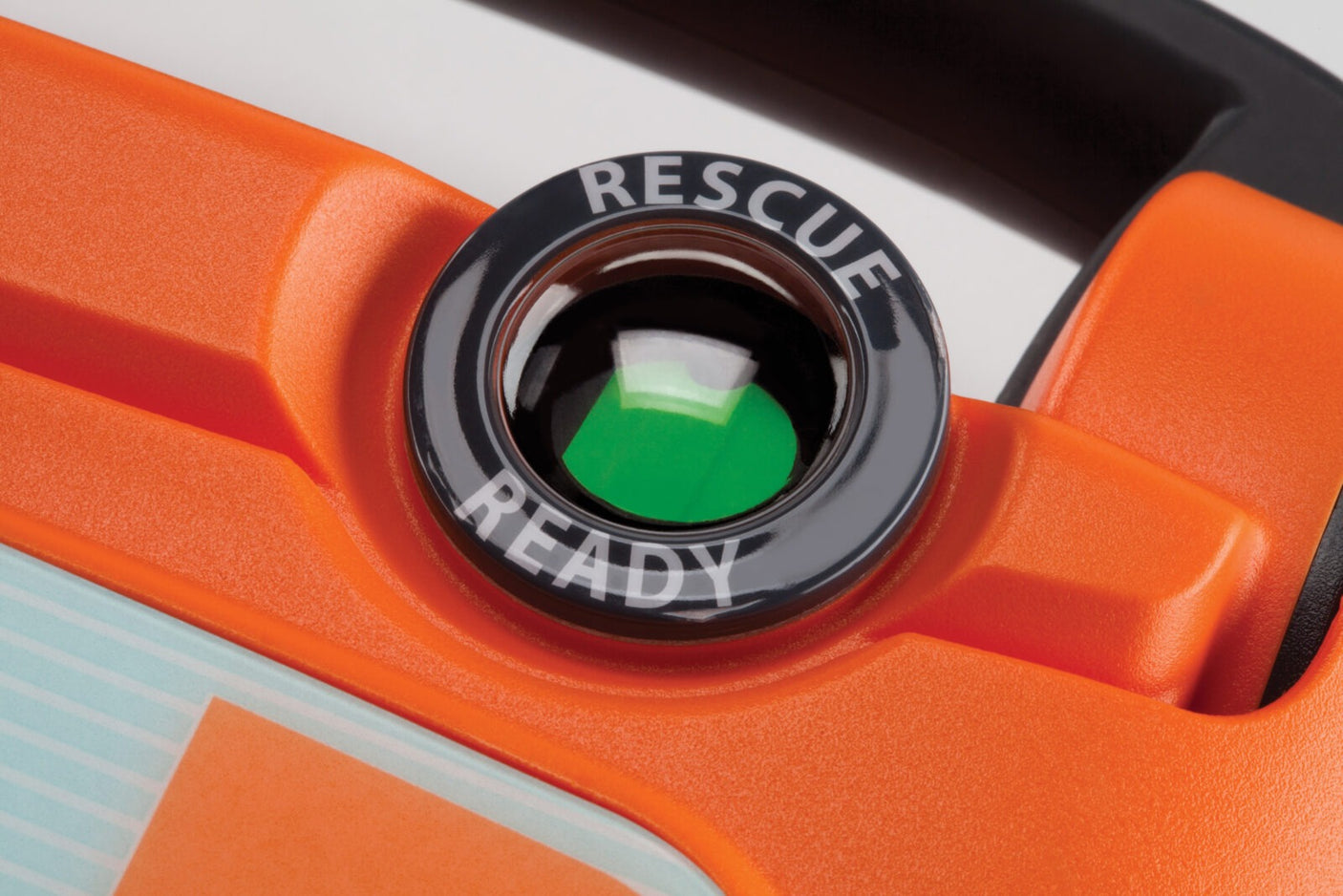 Close-up of a device with the circular green indicator labeled "RESCUE READY" on a bright orange background, showcasing state-of-the-art Rescue Ready technology from the Cardiac Science G5 BILINGUAL AED.