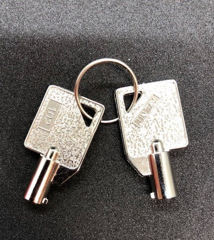 Two AED Shop silver keys on a key ring, placed against a dark background, with one key marked Key 102.