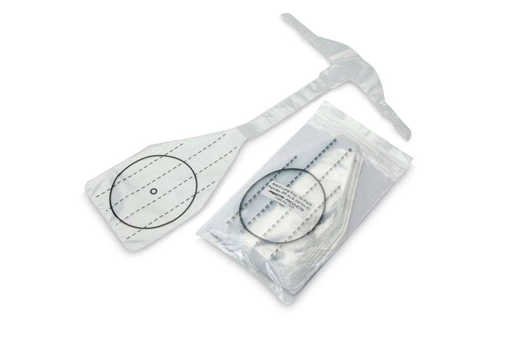 A medical device package with a flat, paddle-like component and circular markings, next to a partially opened package of Prestan Professional Adult CPR-AED Training Manikin Face Shield Lung Bags (Package of 50).