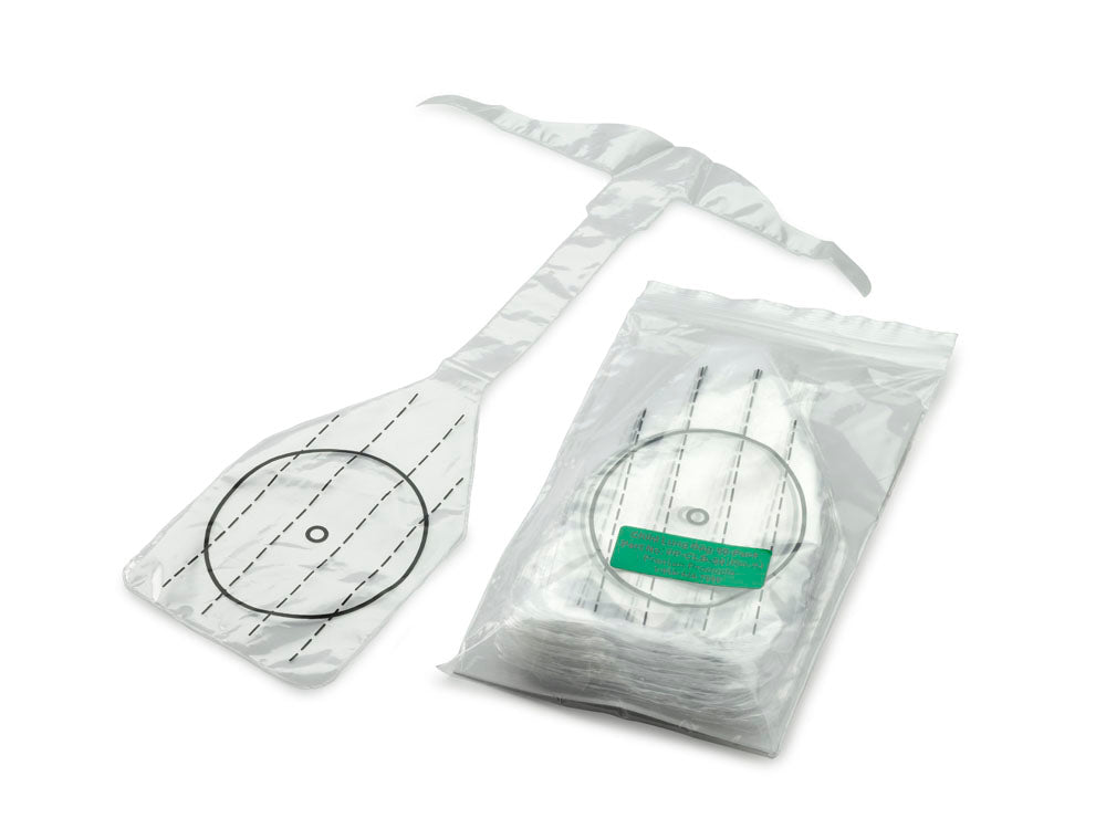 A stack of opened and unopened urine bags with measurement markings and tubes for medical use, alongside a package of 50 Prestan Professional Child Face Shield Lung Bags for manikin training.