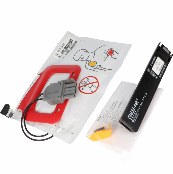 Heart defibrillator equipment with a cable and manual on a white background