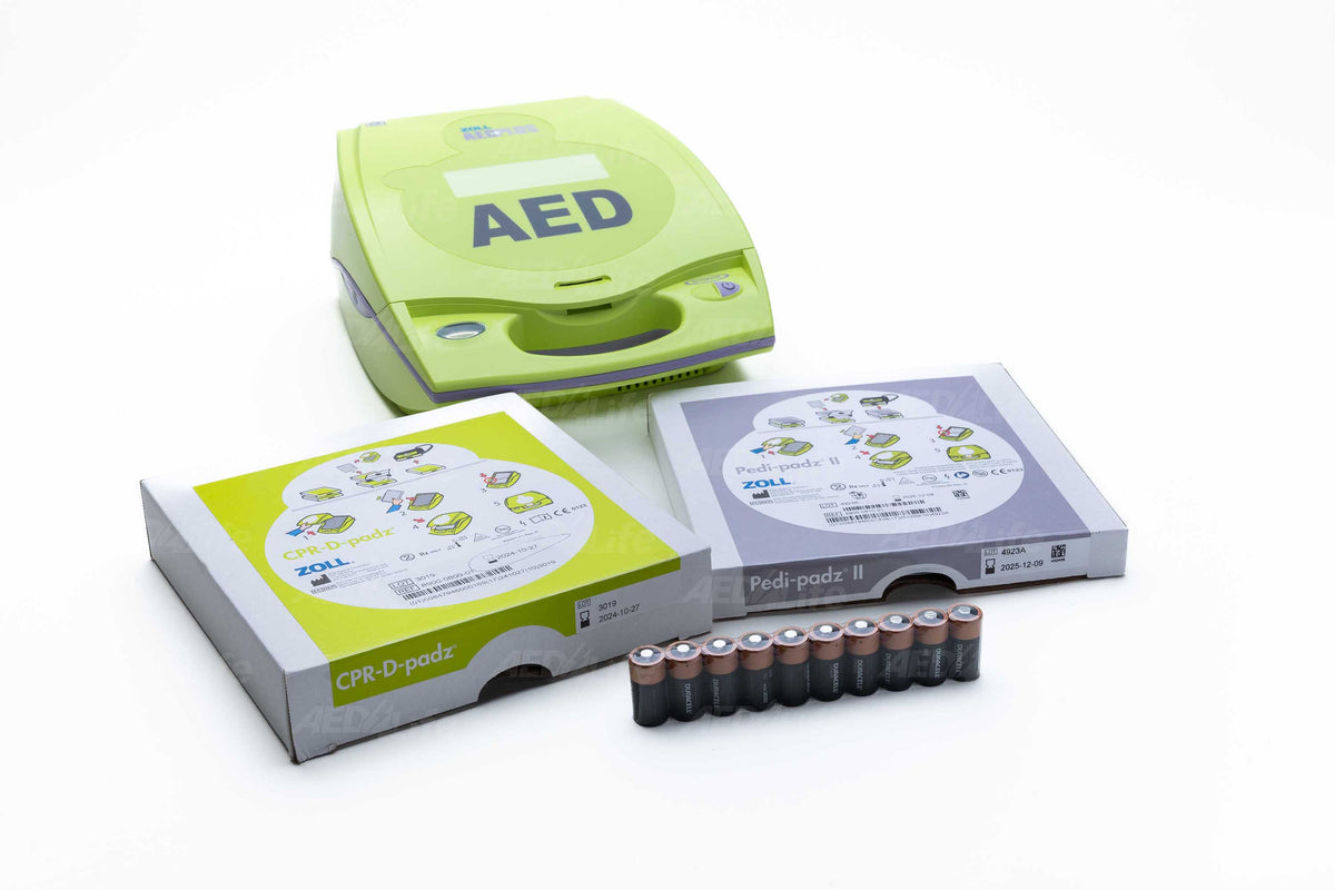 AED device with electrode pads and batteries on a white background