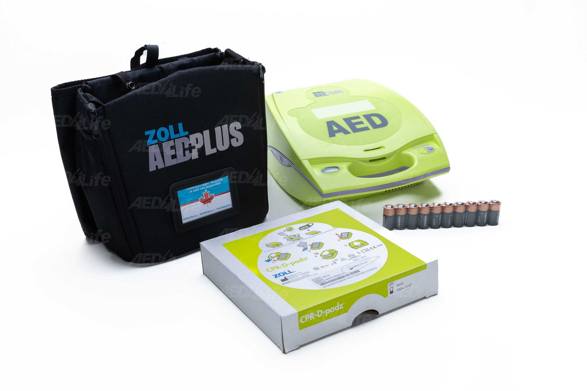 ZOLL AED Plus kit with defibrillator, carrying case, CPR-D padz, and batteries arranged on a white surface.